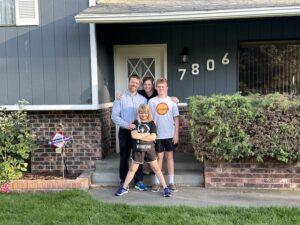 Krista Hopkins Homes Home Buyers in Pasco Stand in Front of Their New Home